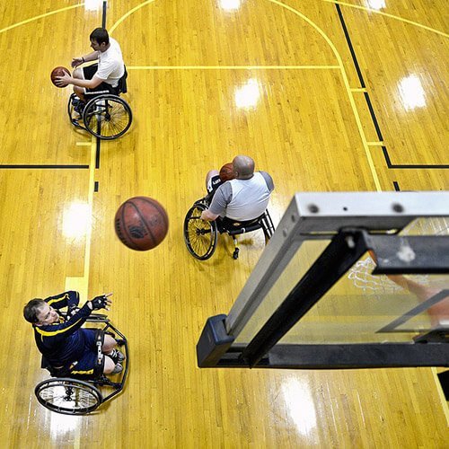 Three Men Playing Wheelchair Basketball